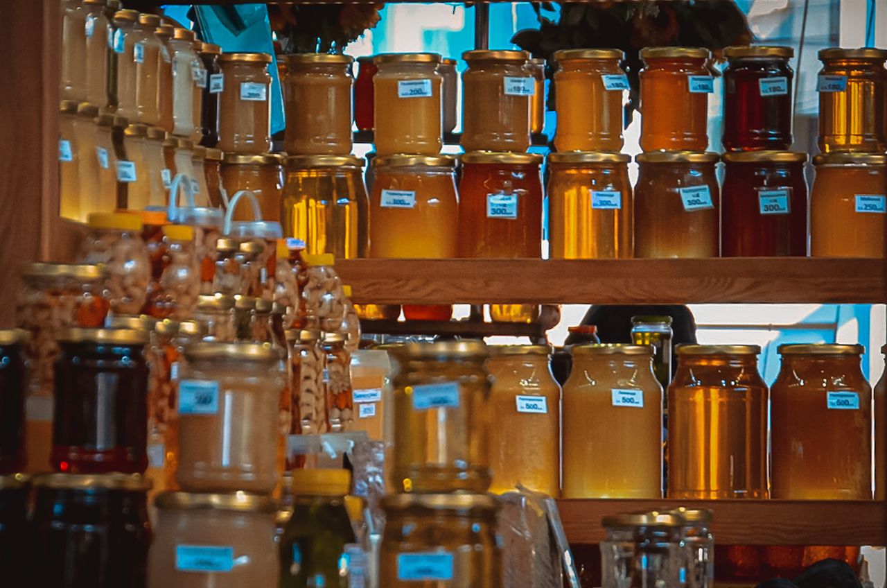 Crafting Captivating Headlines: Your awesome post title goes here A vibrant collection of honey jars on wooden shelves, capturing the golden hues and natural sweetness.